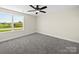 Bedroom showcasing a bright window, neutral walls, and gray carpet at 3012 Isle Ln, Monroe, NC 28110