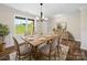 Dining room features a rustic wood table, seating for six and view of a large yard at 3012 Isle Ln, Monroe, NC 28110