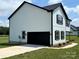 Spacious two-story home featuring white siding, black trim, with an attached garage and concrete driveway at 3012 Isle Ln, Monroe, NC 28110