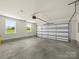 Spacious garage with natural light, concrete floor, and a modern door system at 3012 Isle Ln, Monroe, NC 28110