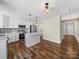 Bright kitchen features stainless steel appliances, an island, and beautiful wood floors at 3012 Isle Ln, Monroe, NC 28110