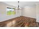 Living room features board and batten accents, wood floors and a view of the yard at 3012 Isle Ln, Monroe, NC 28110