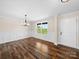 Living room featuring board and batten accents, wood floors and a view of the yard at 3012 Isle Ln, Monroe, NC 28110