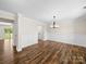 A living room featuring board and batten accents, wood floors and a large entry way at 3012 Isle Ln, Monroe, NC 28110