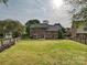 Expansive backyard featuring a well-manicured lawn, patio area, and full perimeter fencing at 3017 Planters Walk Ct, Charlotte, NC 28210