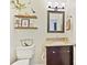 Charming powder room features a granite countertop vanity, wood shelves with decorative items, and a mirror at 3017 Planters Walk Ct, Charlotte, NC 28210