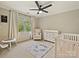 Well-lit Bedroom with a crib, chair, changer, and window for plenty of natural light at 3017 Planters Walk Ct, Charlotte, NC 28210