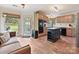 Bright kitchen featuring terracotta tile flooring, light wood cabinets, and a center island at 3017 Planters Walk Ct, Charlotte, NC 28210