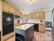 Bright kitchen showcasing light wood cabinets, stainless steel appliances, and a functional center island at 3017 Planters Walk Ct, Charlotte, NC 28210