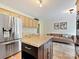 Bright kitchen features a functional island, stainless steel refrigerator, and seamless flow to the living area at 3017 Planters Walk Ct, Charlotte, NC 28210