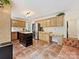 Open concept kitchen with an island, stainless steel refrigerator, and seamless flow to the living area at 3017 Planters Walk Ct, Charlotte, NC 28210