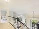 Open-concept living room with fireplace, large windows, and staircase leading down to the lower level at 3017 Planters Walk Ct, Charlotte, NC 28210