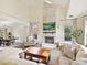 Living room with brick fireplace open to dining room at 3017 Planters Walk Ct, Charlotte, NC 28210