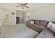Spacious living room with comfortable seating and an adjacent office featuring desk and computer setup at 3017 Planters Walk Ct, Charlotte, NC 28210