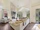 Bright living room featuring a brick fireplace, vaulted ceilings, and hardwood floors at 3017 Planters Walk Ct, Charlotte, NC 28210