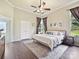 Comfortable main bedroom with a ceiling fan, hardwood floors, and natural light from the exterior at 3017 Planters Walk Ct, Charlotte, NC 28210