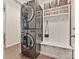 Functional mudroom boasts a stackable washer and dryer unit, white shelving, and bench with storage at 3017 Planters Walk Ct, Charlotte, NC 28210