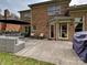 Back patio area with brick facade, outdoor seating, and a grill, perfect for entertaining at 3017 Planters Walk Ct, Charlotte, NC 28210