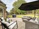 Outdoor patio featuring a seating area with an umbrella, grill, and well-maintained lawn at 3017 Planters Walk Ct, Charlotte, NC 28210