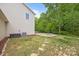 Grassy backyard with fire pit and lush landscaping at 303 Landis Oak Way, Landis, NC 28088