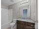 Bathroom features a modern vanity with granite countertop, tub-shower combo and neutral color palette at 303 Landis Oak Way, Landis, NC 28088