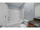 Well-lit bathroom featuring a shower-tub combination, vanity, toilet, and neutral color scheme at 303 Landis Oak Way, Landis, NC 28088