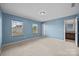 Comfortable bedroom bathed in natural light from two windows and en-suite access to the bathroom at 303 Landis Oak Way, Landis, NC 28088