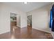 A versatile empty room featuring hardwood flooring and neutral wall colors at 303 Landis Oak Way, Landis, NC 28088