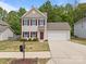 Charming two-story home with a well-maintained lawn and attached two-car garage at 303 Landis Oak Way, Landis, NC 28088