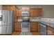 Kitchen featuring stainless steel appliances and ample counter space with wooden cabinets at 303 Landis Oak Way, Landis, NC 28088