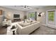 Bright living room with modern furnishings, neutral colors, and natural light from the windows at 303 Landis Oak Way, Landis, NC 28088