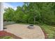 Outdoor patio area with a built-in fire pit, perfect for outdoor entertaining at 303 Landis Oak Way, Landis, NC 28088