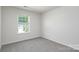 Bright, carpeted bedroom with a sunlit window, offering a comfortable and private space at 3056 Ora Smith Rd, Lincolnton, NC 28092