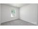 Comfortable, carpeted bedroom featuring a sunlit window, providing a private and cozy retreat at 3056 Ora Smith Rd, Lincolnton, NC 28092