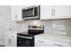 Modern kitchen with stainless steel microwave and oven, and white cabinets at 3056 Ora Smith Rd, Lincolnton, NC 28092