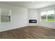 Spacious living room with wood flooring, modern fireplace, and bright windows at 3056 Ora Smith Rd, Lincolnton, NC 28092