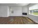 Open living space featuring wood floors, a contemporary fireplace, and natural light at 3056 Ora Smith Rd, Lincolnton, NC 28092