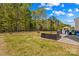 Expansive backyard features a lush lawn, patio with outdoor seating, a grill, and a basketball hoop at 320 Silver Oak Cir, Rockwell, NC 28138