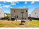 Wide-open backyard with a basketball hoop, grill, patio area, and well-maintained lawn, ideal for outdoor living at 320 Silver Oak Cir, Rockwell, NC 28138