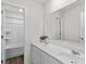 Bright bathroom with double sink vanity, hard wood floors, and large mirror at 320 Silver Oak Cir, Rockwell, NC 28138