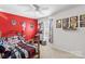 Bedroom featuring red accent wall and sports decor at 320 Silver Oak Cir, Rockwell, NC 28138