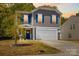 Well-maintained home with a two-car garage, and a welcoming front porch at 320 Silver Oak Cir, Rockwell, NC 28138