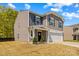 Two-story home featuring a two-car garage and a covered front porch at 320 Silver Oak Cir, Rockwell, NC 28138