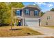 Attractive home featuring a two-car garage, covered front porch, and well-kept lawn at 320 Silver Oak Cir, Rockwell, NC 28138