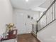 Bright foyer with hardwood floors, white walls, and staircase with rod iron spindles at 320 Silver Oak Cir, Rockwell, NC 28138
