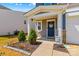 Charming front porch adorned with a welcome sign and beautiful landscaping at 320 Silver Oak Cir, Rockwell, NC 28138