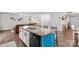 Bright kitchen with an island that has bar stools and granite countertops with adjacent living room at 320 Silver Oak Cir, Rockwell, NC 28138