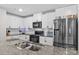 Modern kitchen featuring granite countertops, subway tile backsplash, and stainless steel appliances at 320 Silver Oak Cir, Rockwell, NC 28138