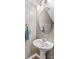 Powder room with a modern basin sink and oval mirror at 320 Silver Oak Cir, Rockwell, NC 28138