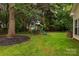 Spacious backyard featuring a playset, lush lawn, and mature trees for outdoor activities at 3404 Pasture View Ct, Charlotte, NC 28269